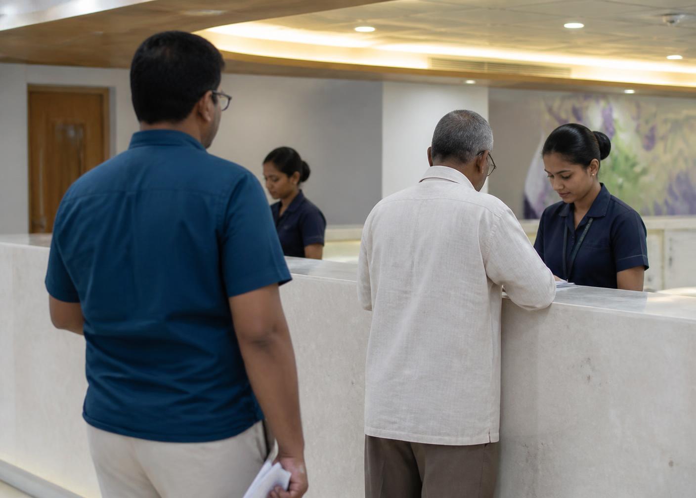 Hospital reception counter with staff attending to visitors